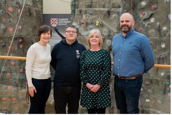 Queens Sport Host Cabrini Tsougranis, Richard Collis Inclusive Employment Scheme Placement, Sally Lynn QUB Diversity Inclusion & Wellbeing Unit and Support Worker Alan Horne Orchardville,  standng in front of a climbing wall